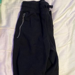 Black sweat pants with zippers, stretchy Waist.